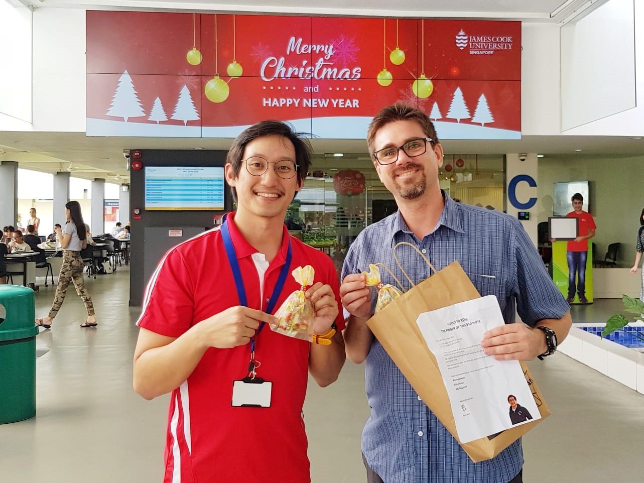 Dr Jose Domingos giving out chocolates to the security guards and cleaners